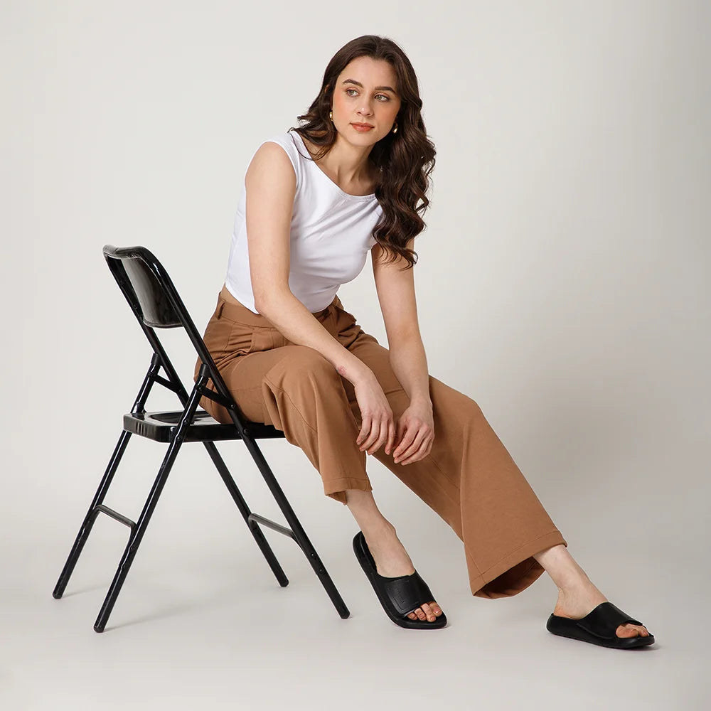 Premium NoStrain black leather footwear for women with adjustable broad straps and durable outsole.