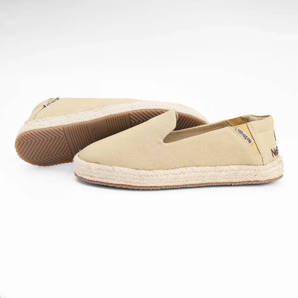 NoStrain women's beige canvas loafers with decorative cotton lace trim and a flexible sole.