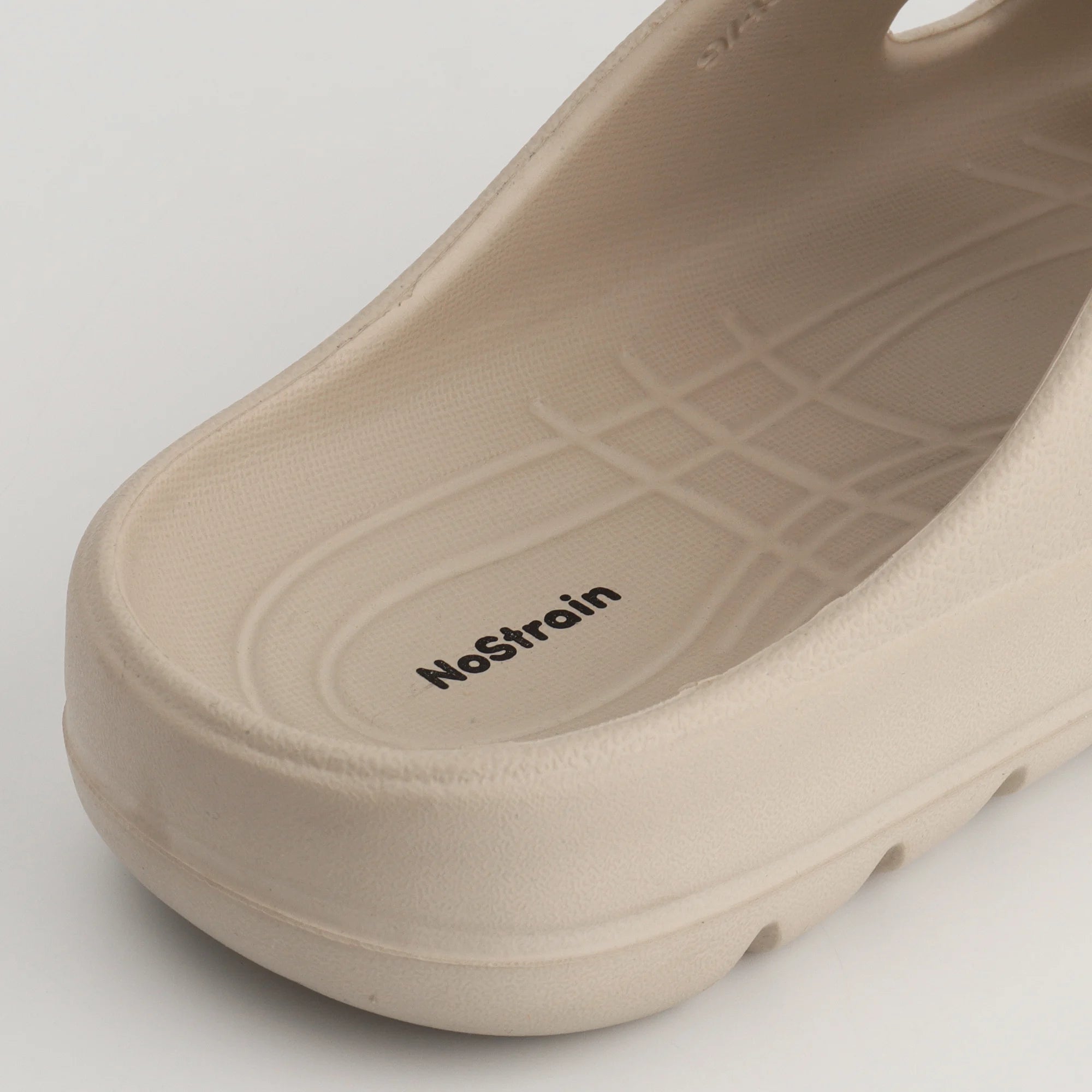 featuring beige EVA sandals on a boardwalk.