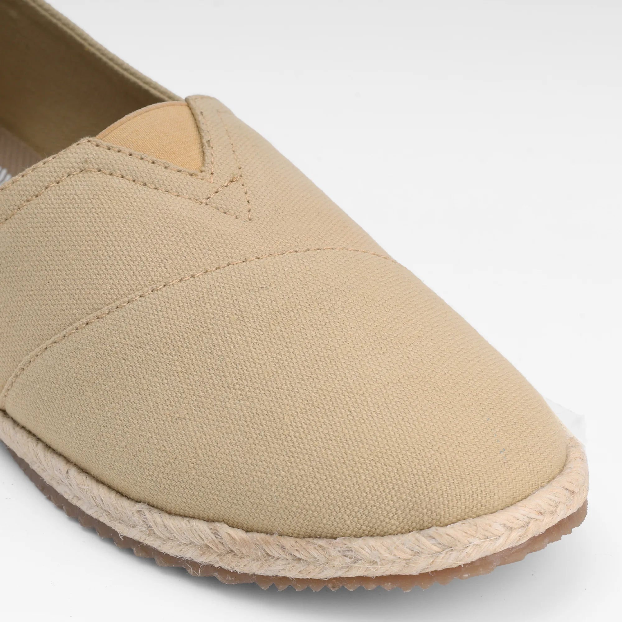 Men's slip on canvas shoes in beige by NoStrain with a durable rubberized anti-skid outsole.