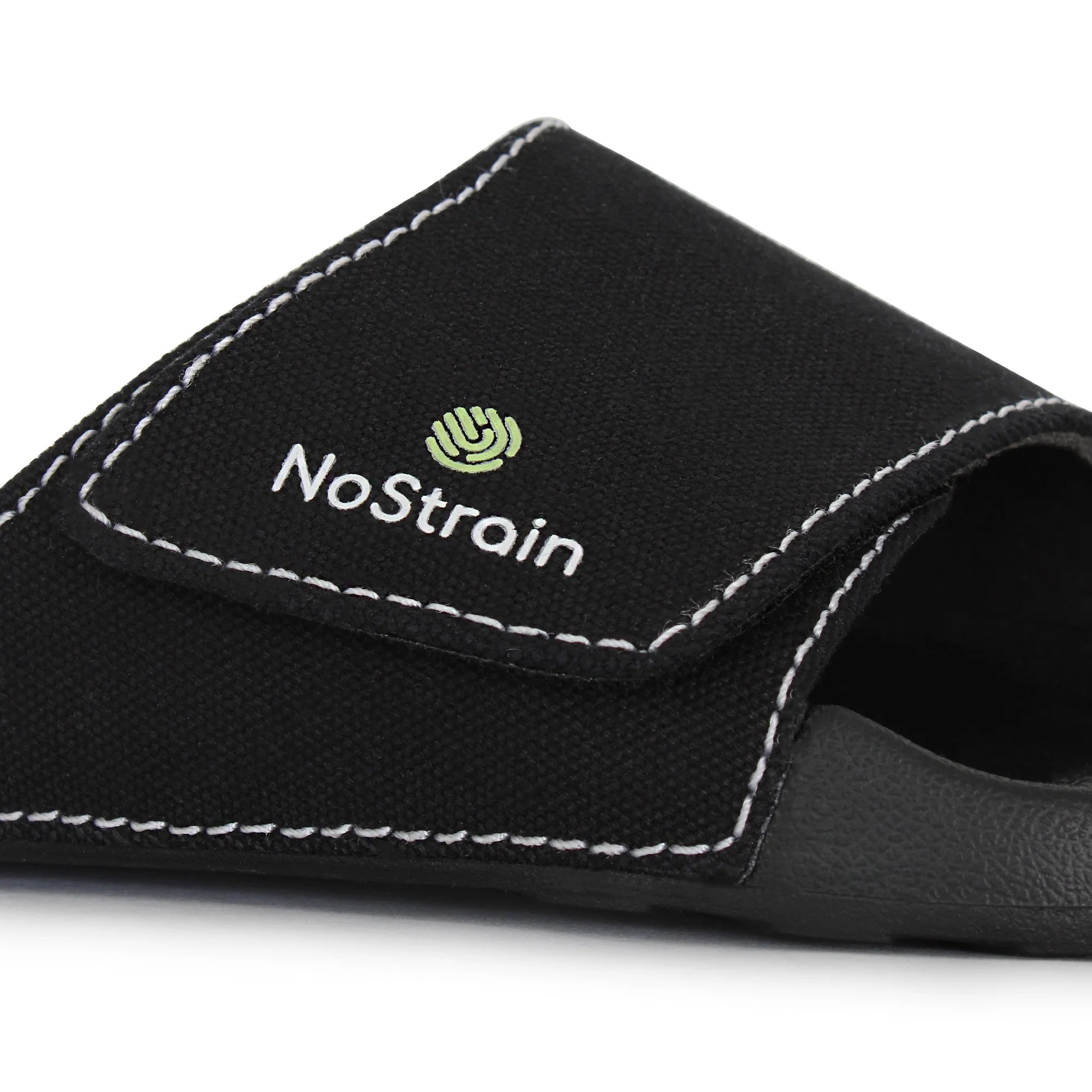 Close-up of men's black canvas sugar sliders, showcasing the stitched details.