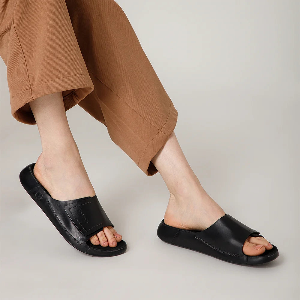 NoStrain women black leather sliders with broad strap design and ISI marked premium quality.