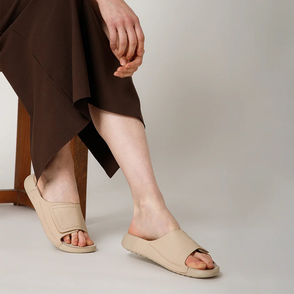 NoStrain women beige leather sliders with broad strap design and ISI marked premium quality.
