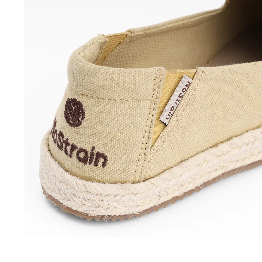 Comfortable women’s beige canvas shoes by NoStrain featuring an elastic upper for a perfect fit.
