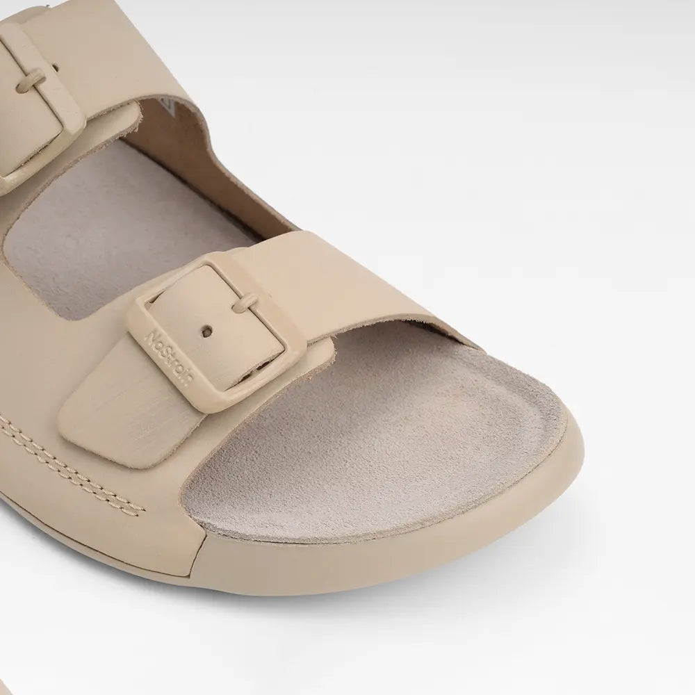 NoStrain beige leather sandals for women with stylish front buckle closures.