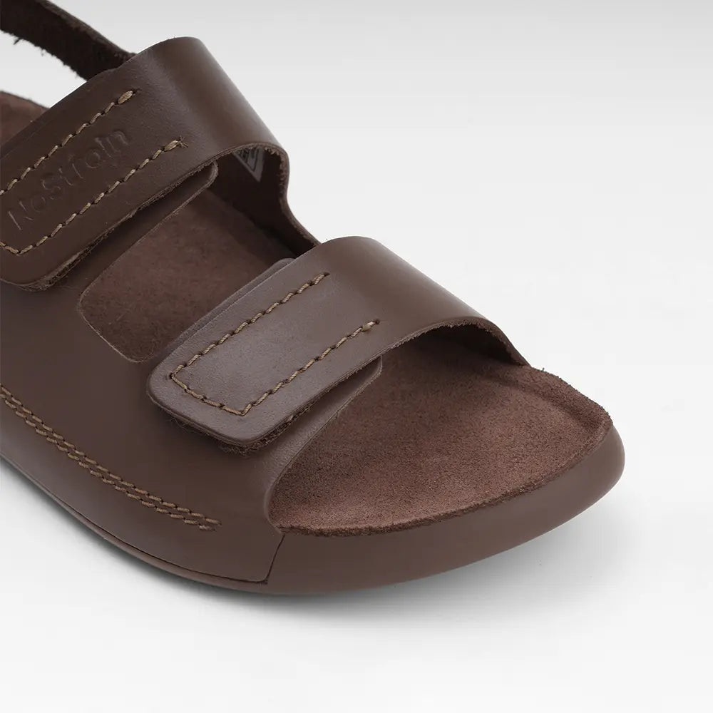 Handcrafted brown leather footwear for women by NoStrain featuring adjustable straps for a perfect fit.